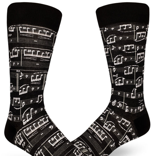 Black crew socks for men with allover sheet music design in white.