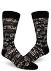 Black crew socks for men with allover sheet music design in white.