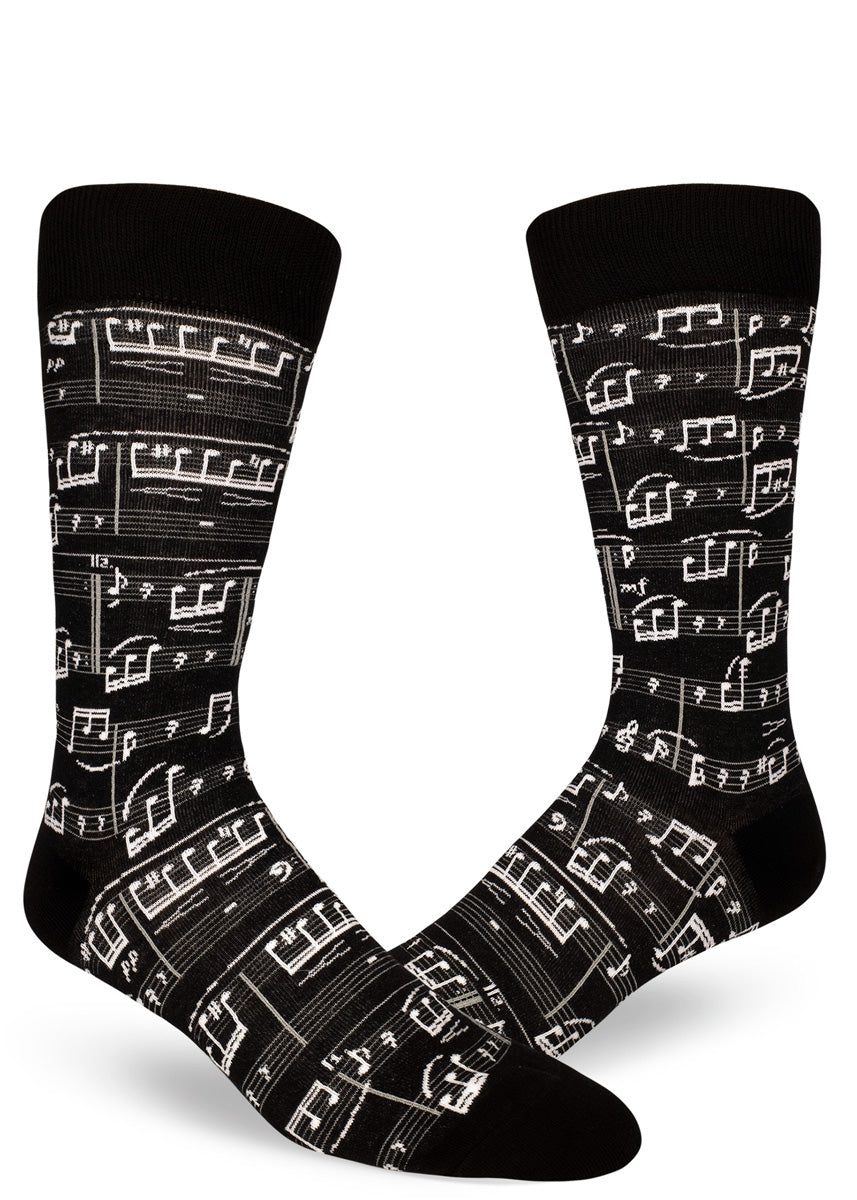 Black crew socks for men with allover sheet music design in white.