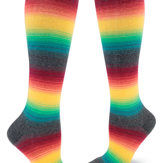 Muted rainbow knee socks with gradients of color and gray. 
