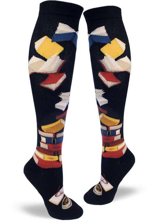 Black knee socks with stacked multicolored books, flying books at the top and an open book with glasses and cup below.