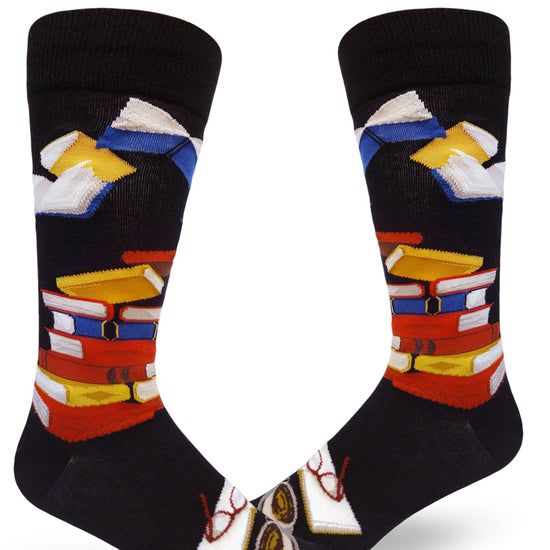 Black crew socks for men with colorful book design, with books in stacks and open.