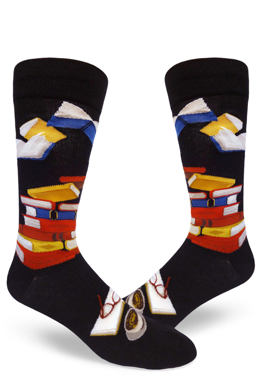 Black crew socks for men with colorful book design, with books in stacks and open.