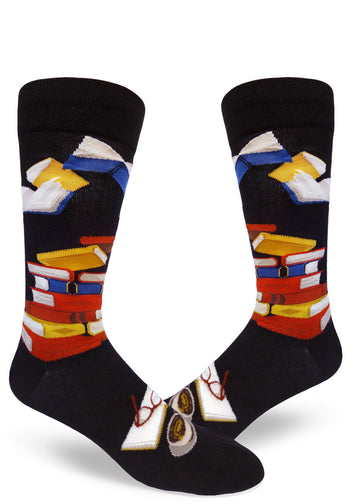 Black crew socks for men with colorful book design, with books in stacks and open.