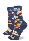 Blue crew socks for women with stacks of books and books flying through the air, with an open book, glasses and cup at the bottom.
