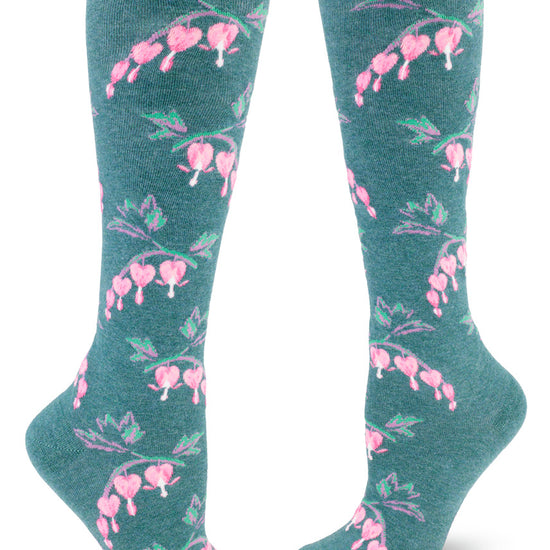 Teal knee socks with allover repeating pattern of pink bleeding heart flowers.