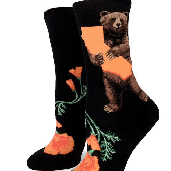 Black crew socks for women with brown bears holding orange outlines of California above orange California poppies.