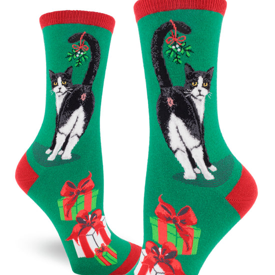 Red and green Christmas crew socks for women with black and white cats showing their butts with mistletoe on their tails and wrapped presents.
