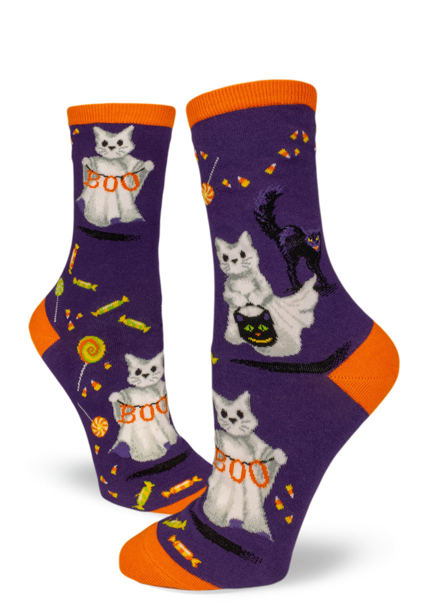 Purple crew socks for women with Halloween cats in ghost costumes, black scaredy cats and candy.