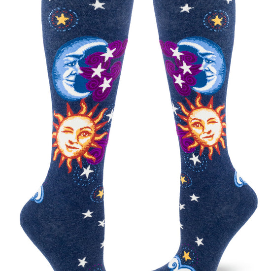 Navy knee socks with suns and moons with faces, with sun winking, purple clouds and stars.