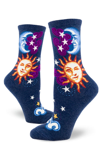 Navy blue crew socks for women with sun, moon and stars design, with faces on sun and moon.
