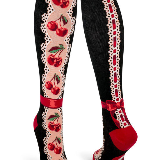Black and red knee socks with red cherries on an eyelet lace pattern with faux red ribbon around the ankle and a lace and ribbon back seam.