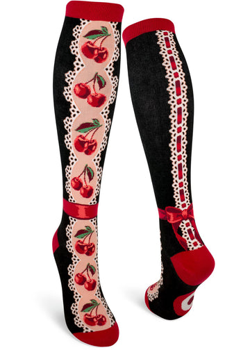 Black and red knee socks with red cherries on an eyelet lace pattern with faux red ribbon around the ankle and a lace and ribbon back seam.