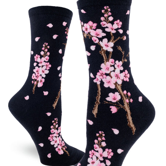 Dark navy crew socks for women with pink cherry blossoms and pink petals falling.