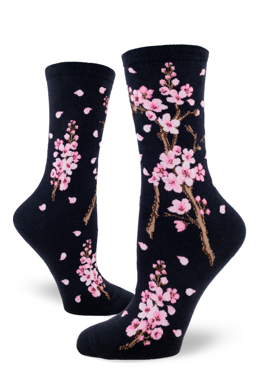 Dark navy crew socks for women with pink cherry blossoms and pink petals falling.