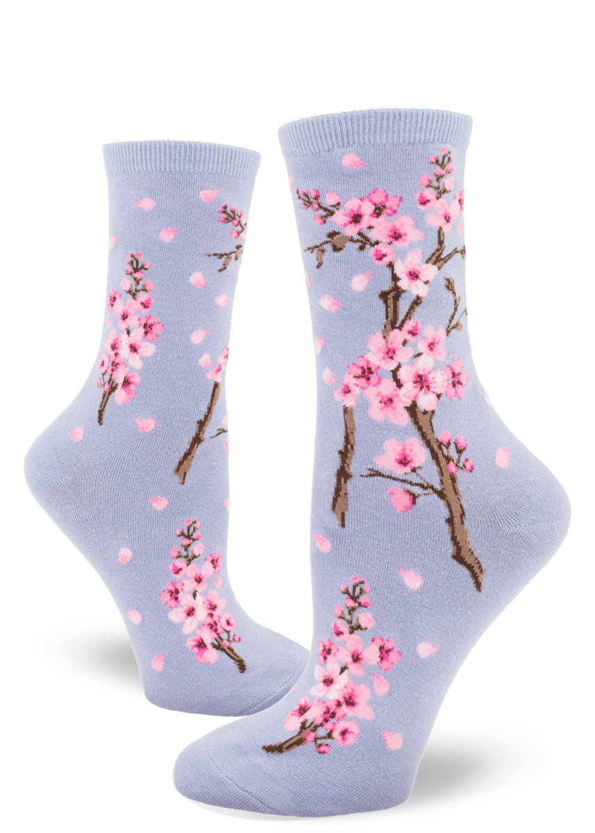Light purple women's crew socks with pink cherry blossoms and falling petals.