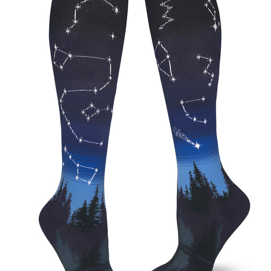 Blue gradient knee socks with night sky pattern and stars in constellations above a forest and lake.