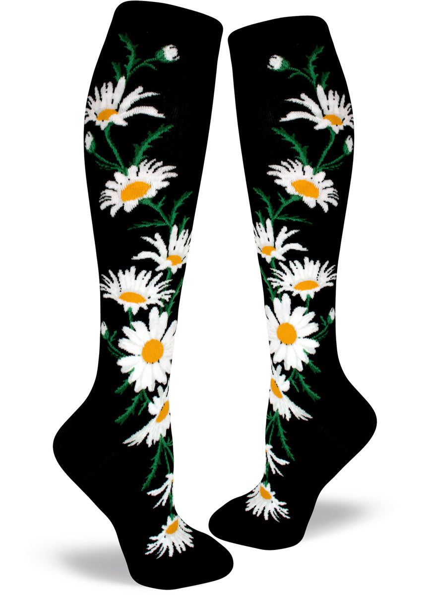 Black knee socks with large white and yellow daisy flowers.