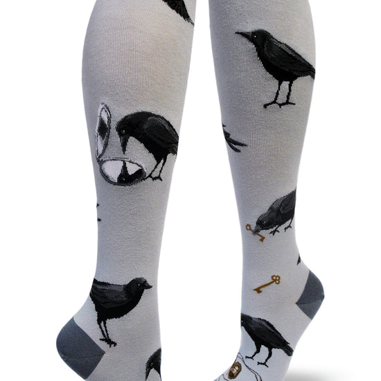Gray knee socks with black crows flying, looking into mirrors and holding keys in their beaks and locket necklaces.