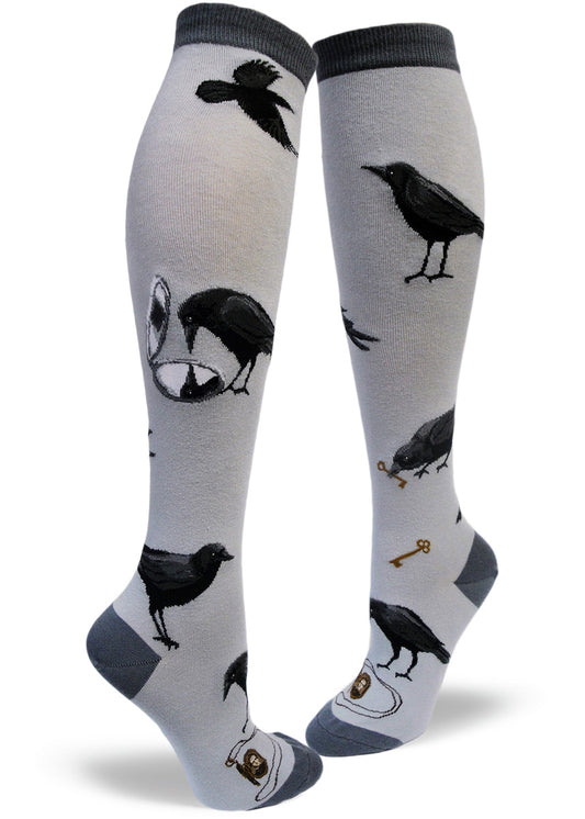 Gray knee socks with black crows flying, looking into mirrors and holding keys in their beaks and locket necklaces.
