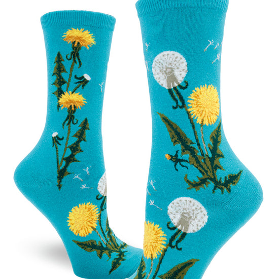 Blue crew socks for women with dandelion flowers and seed heads along with seeds flying.