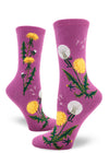 Purple crew socks for women with dandelion flowers, leaves and seed heads with flying dandelion scenes above.