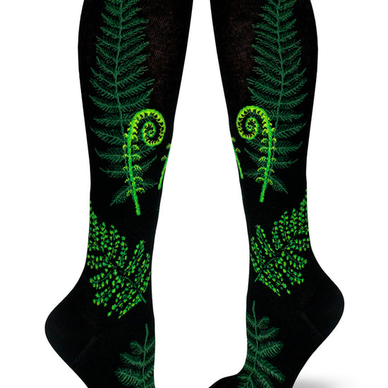 Black knee socks with green ferns and fiddleheads of different varieties.