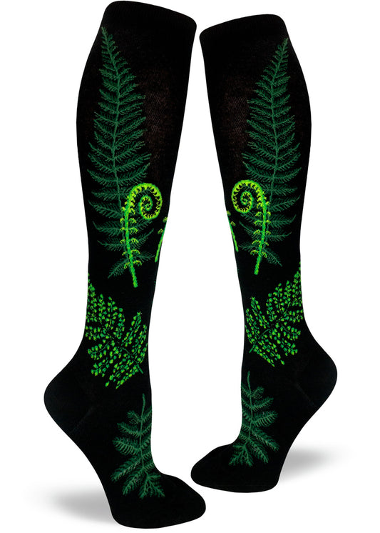 Black knee socks with green ferns and fiddleheads of different varieties.