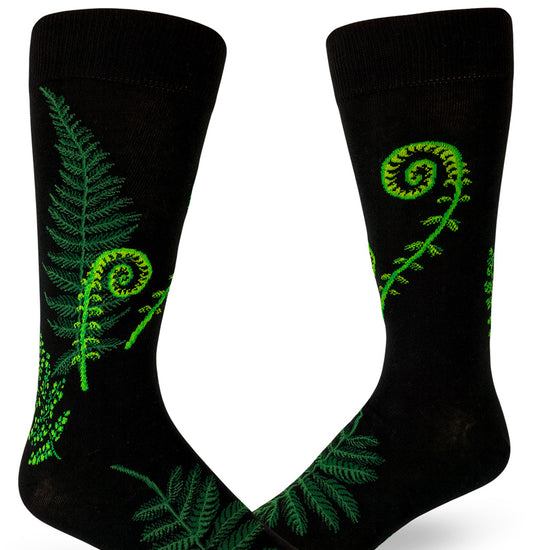 Black crew socks for men with green ferns and curly fiddleheads.