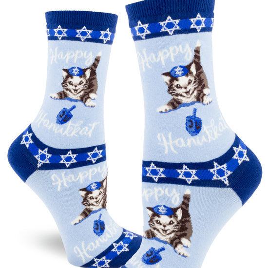 Blue crew socks for women with playful cats in yarmulkes, dreidels and stars of David with the words "Happy Hanukkat."