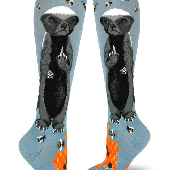 Slate blue knee socks with angry badgers giving the finger while surrounded by bees, and orange honeycomb at the base.