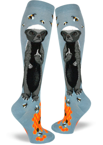 Slate blue knee socks with angry badgers giving the finger while surrounded by bees, and orange honeycomb at the base.