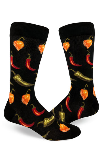 Black crew socks for men with allover repeating pattern of spicy orange, red and green chili peppers.