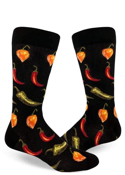 Black crew socks for men with allover repeating pattern of spicy orange, red and green chili peppers.