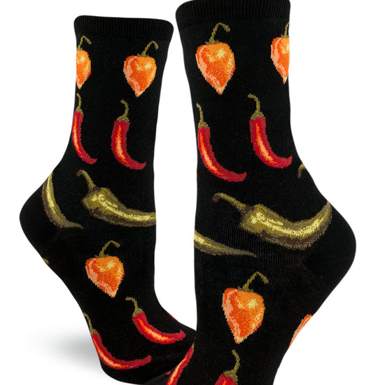 Women's crew socks with repeating pattern of red, orange and green hot peppers arranged in rows against a black background.