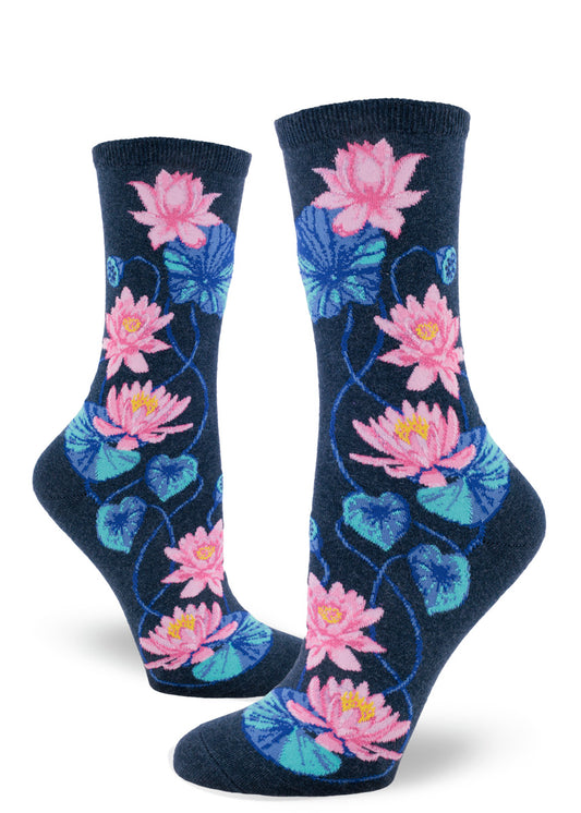 Navy crew socks for women with floral pattern of pink lotuses and blue leaves and seed pods.