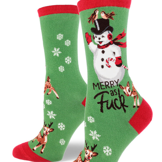 Green crew socks for women with red accents and the words "Merry as Fuck" beneath a cheerful snowman along with snowflakes and reindeer.