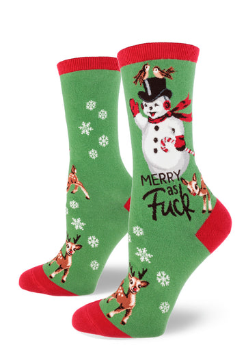 Green crew socks for women with red accents and the words "Merry as Fuck" beneath a cheerful snowman along with snowflakes and reindeer.