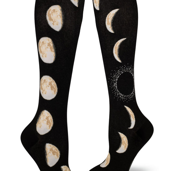 Black knee high socks with moon design with different phases of the moon rising up the sides.
