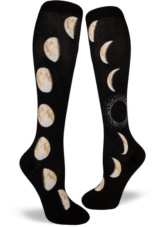 Black knee high socks with moon design with different phases of the moon rising up the sides.