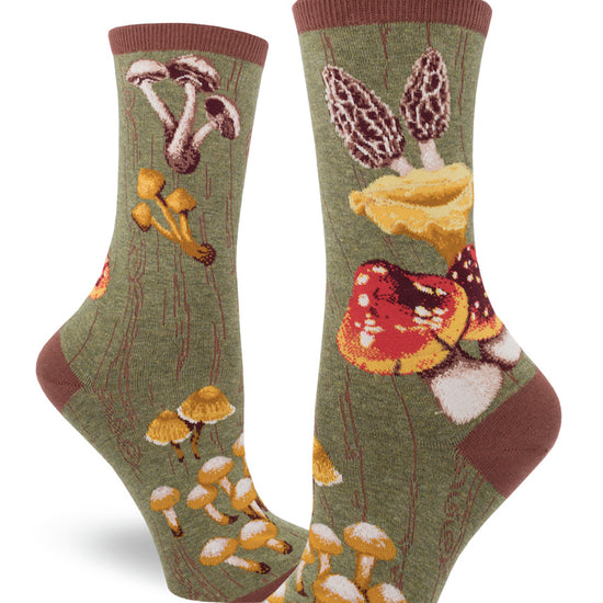 Green crew socks for women with bold wild mushrooms against a mossy tree bark base.