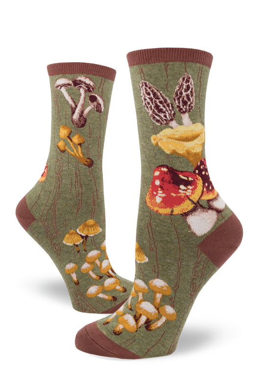 Green crew socks for women with bold wild mushrooms against a mossy tree bark base.