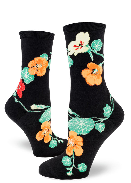 Black crew socks for women with nasturtium flowers in red, orange and yellow, and green foliage.