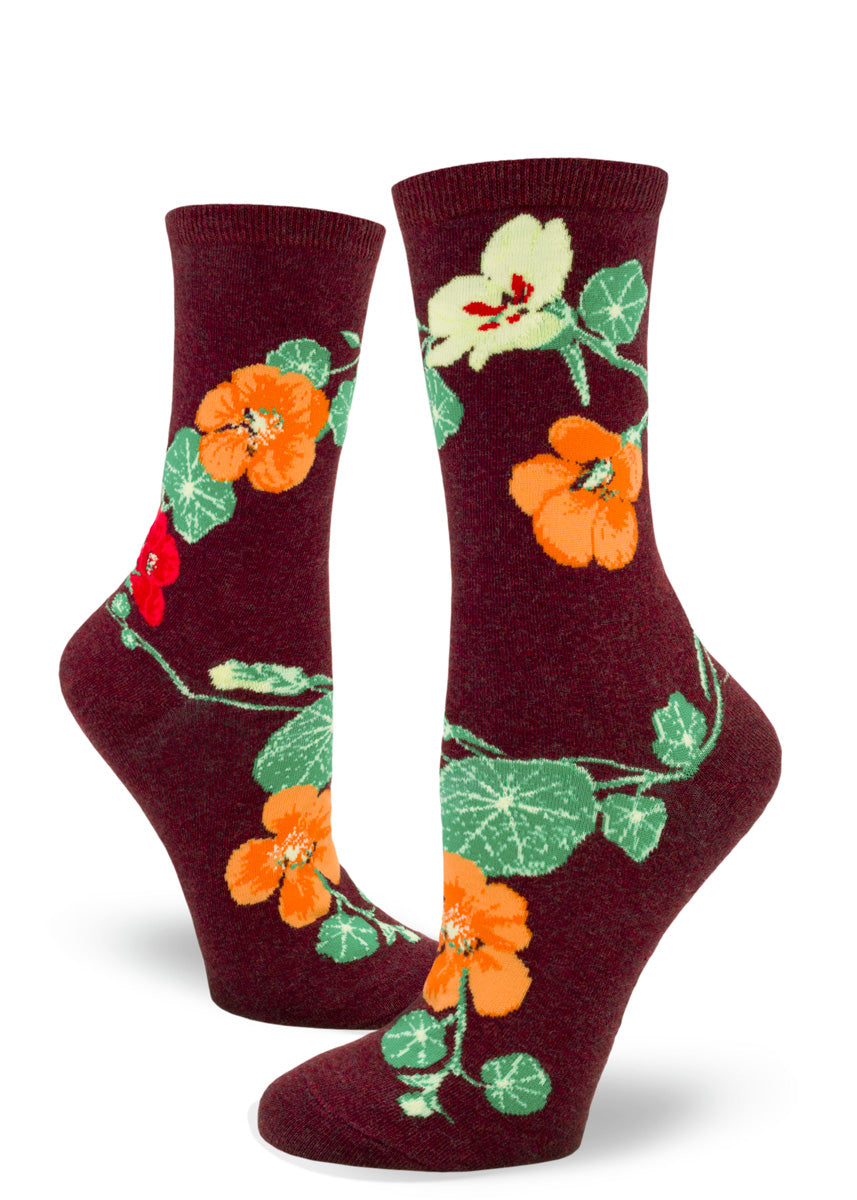 Maroon crew socks for women with floral design of nasturtiums in res, orange and yellow and green leaves.