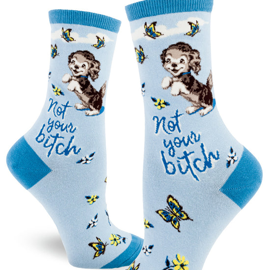 Blue women's crew socks with the words "Not your bitch" below a cute dog beside butterflies and flowers.