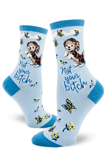 Blue women's crew socks with the words "Not your bitch" below a cute dog beside butterflies and flowers.