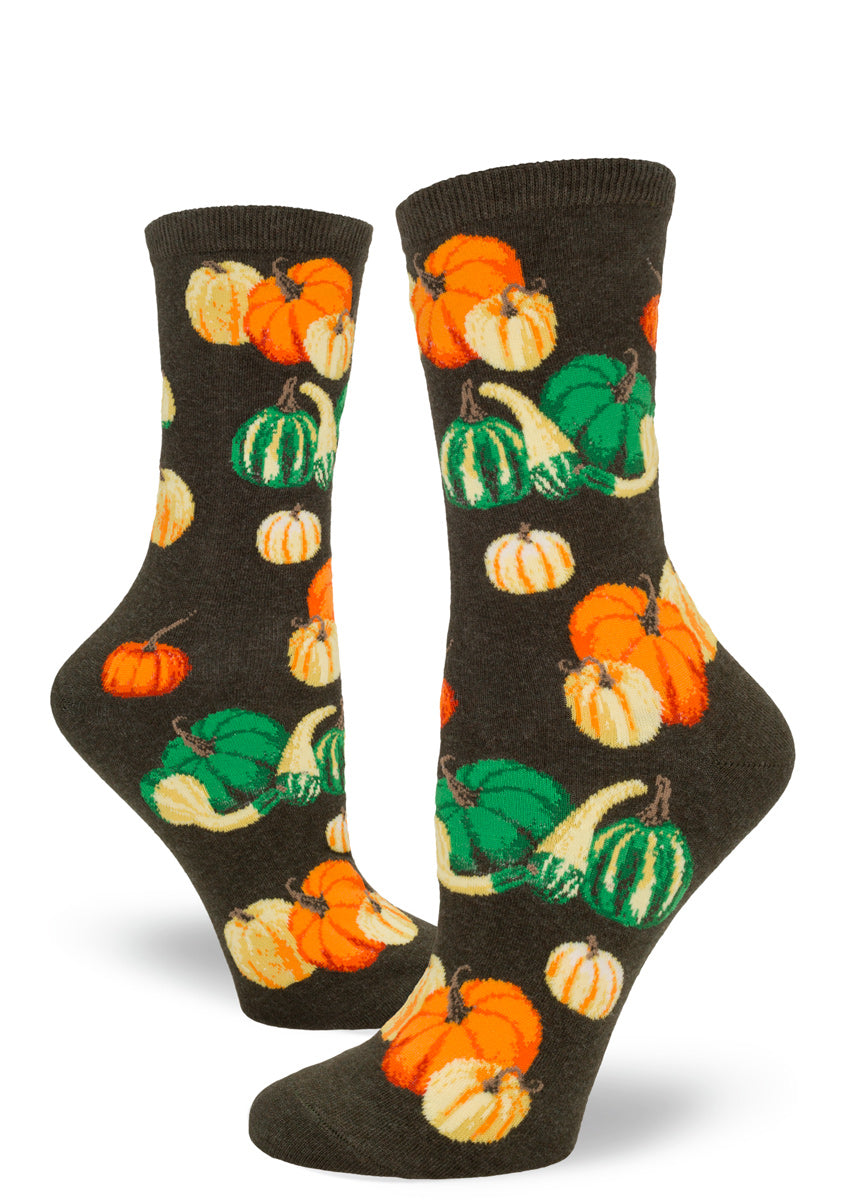 Green women's crew socks with orange pumpkins and colorful gourd varieties.