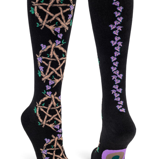 Black knee-high socks with wooden vine pentacles a back seam made of purple leaves.