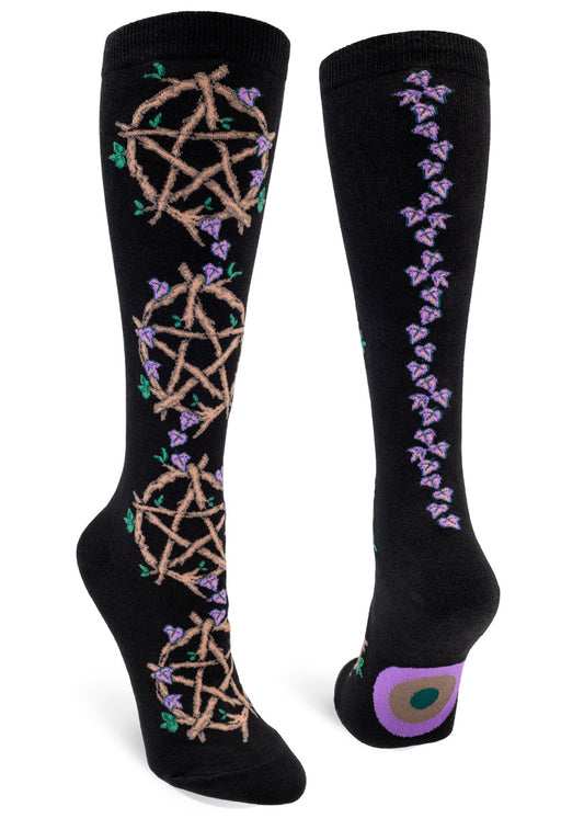Black knee-high socks with wooden vine pentacles a back seam made of purple leaves.