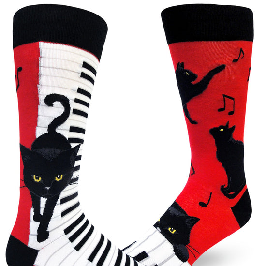 Black, white and red crew socks for men with black cats walking on piano keys and playing with music notes.